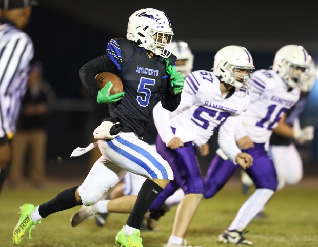 Burlington Central's Lucas Kerr (5)returns a fourth quarter interception 24 yards against Hampshire during a Fox Valley Conference game in Burlington on Friday, Oct. 18, 2024.(H. Rick Bamman / The Beacon-News)