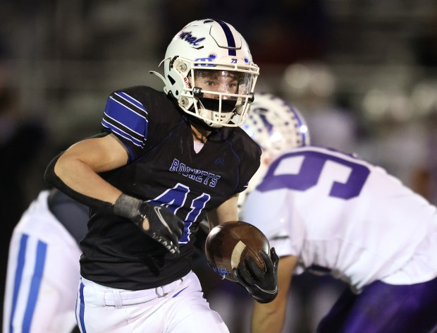 Burlington Central's Jack Aguirre (41) runs for a first down in the fourth quarter against Hampshire during a Fox Valley Conference game in Burlington on Friday, Oct. 18, 2024.(H. Rick Bamman / The Beacon-News)