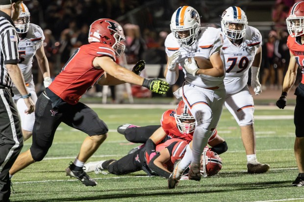 Oswego's Lucas Andersen (2) runs the ball against Yorkville during a Southwest Prairie - West Conference game in Yorkville on Friday, Oct. 11, 2024. (Troy Stolt / for the Beacon-News)