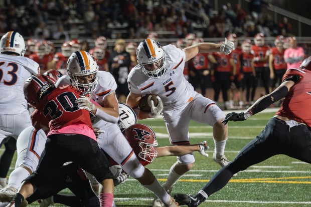 Oswego's Carson Cooney (5) runs the ball against Yorkville during a Southwest Prairie - West Conference game in Yorkville on Friday, Oct. 11, 2024. (Troy Stolt / for the Beacon-News)