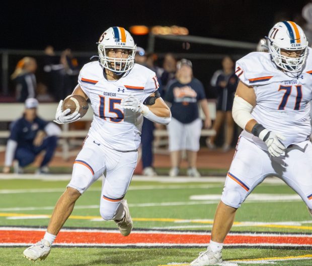 Oswego's Donovan Williams (15) runs the ball against Yorkville during a Southwest Prairie - West Conference game in Yorkville on Friday, Oct. 11, 2024. (Troy Stolt / for the Beacon-News)