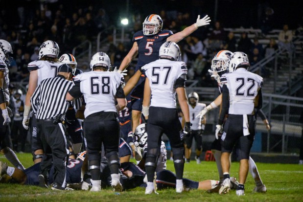 Oswego's Carson Cooney (5) celebrates an Oswego fumble recovery at home against Plainfield North in Oswego on Friday, Sept. 27, 2024. (Mark Black / The Beacon-News)