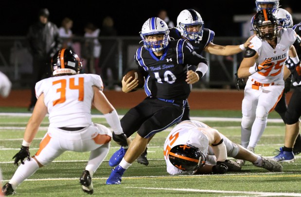 St. Charles North's QB Ethan Plumb center, runs the ball against St. Charles East during game in St. Charles on Friday, Oct. 4, 2024. (James C. Svehla / Beacon News)