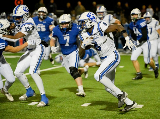 St. Charles North's Joell Holloman (8) runs the ball against Geneva on Friday, Oct. 25, 2024. (Mark Black / for the Beacon-News)