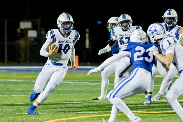 St. Charles North quarterback Ethan Plumb (10) runs the ball against Geneva on Friday, Oct. 25, 2024. (Mark Black / for the Beacon-News)