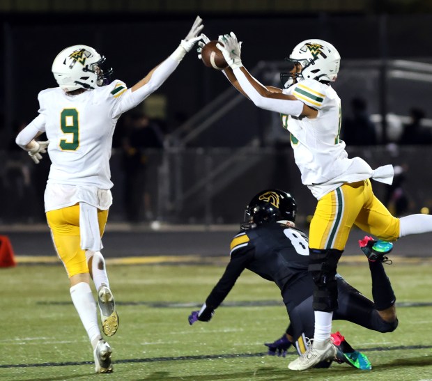 Waubonsie Valley's OwenRoberts, left, and Josh Hungreach for a pass during a game against Metea Valley in Aurora on Friday, Oct. 25, 2024. (James C. Svehla / for the Beacon-News)