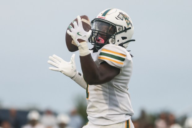 Waubonsie Valley's Chrisjan Simmons (1) makes a catch during a game against Oswego East in Oswego on Friday Aug. 30, 2024. (Troy Stolt / The Beacon News)