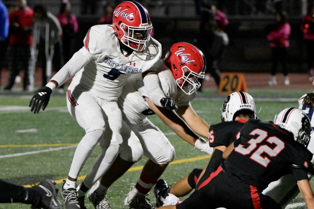 West Aurora's Temilade Dada (5) works the line against East Aurora in Aurora on Friday, Oct. 18, 2024. (Mark Black / for the Beacon-News)