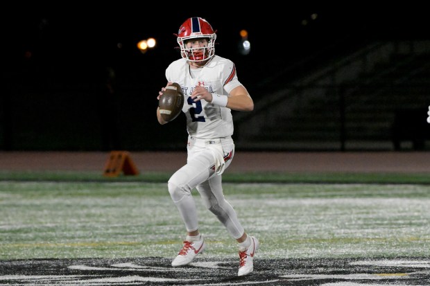 West Aurora quarterback Mason Atkins (2) looks of an open receiver against East Aurora in Aurora on Friday, Oct. 18, 2024. (Mark Black / for the Beacon-News)