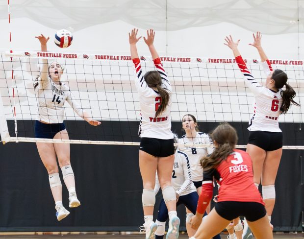 Oswego East's Ali Coy (14) spikes the ball against Yorkville during a Southwest Prairie Conference game in Yorkville on Thursday, Oct. 24, 2024. (Troy Stolt / for the Beacon-News)