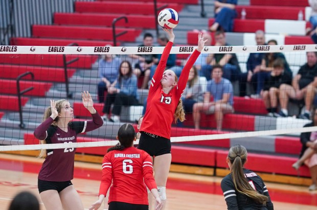 Aurora Christian's Breanna Hard (15) plays the ball at the net against Wheaton Academy during a volleyball match at Aurora Christian High School on Monday, Sep 30, 2024. (Sean King / for The Beacon-News)