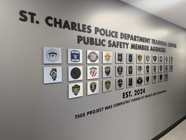 The wall right inside the entrance to the St. Charles Police Department Public Safety Training Center shows all of the agencies that the center will serve. (R. Christian Smith / The Beacon-News)