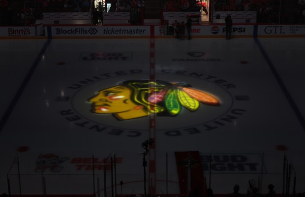 The Blackhawks logo is illuminated on the ice before a preseason game against the Wild on Oct. 4, 2024, at the United Center. (John J. Kim/Chicago Tribune)