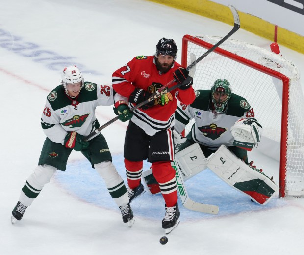 Blackhawks left wing Patrick Maroon (77) and Wild defenseman Jonas Brodin battle for the puck in front of goaltender Marc-Andre Fleury (29) in the second period of a preseason game on Oct. 4, 2024, at the United Center. (John J. Kim/Chicago Tribune)