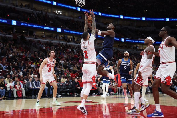 Bulls guard Lonzo Ball (2) defends against Timberwolves guard Anthony Edwards (5) in the first half of a game at the United Center in Chicago on Oct. 16, 2024. (Terrence Antonio James/Chicago Tribune)