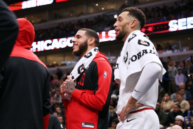 Bulls guard Lonzo Ball, left, and Bulls guard Zach LaVine (8) watch the action in the first half of a game against the Timberwolves at the United Center in Chicago on Oct. 16, 2024. (Terrence Antonio James/Chicago Tribune)