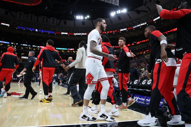 Bulls guard Lonzo Ball, center, heads to the bench during a timeout at the United Center in Chicago in a game against the Timberwolves on Oct. 16, 2024. (Terrence Antonio James/Chicago Tribune)