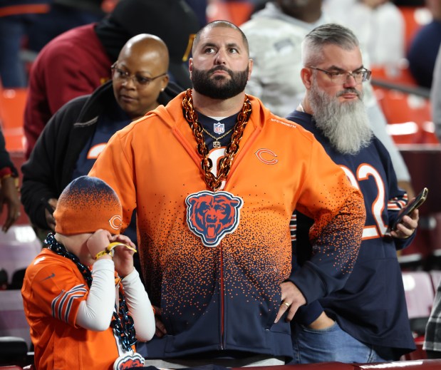 Bears fans stand at their seats after an 18-15 loss to the Commanders at Northwest Stadium. (John J. Kim/Chicago Tribune)