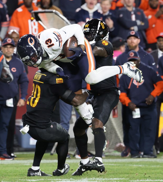 Bears wide receiver Keenan Allen (13) is tackled after a reception by Commanders safety Quan Martin (20) in the fourth quarter at Northwest Stadium on Oct. 27, 2024, in Landover, Maryland. (John J. Kim/Chicago Tribune)