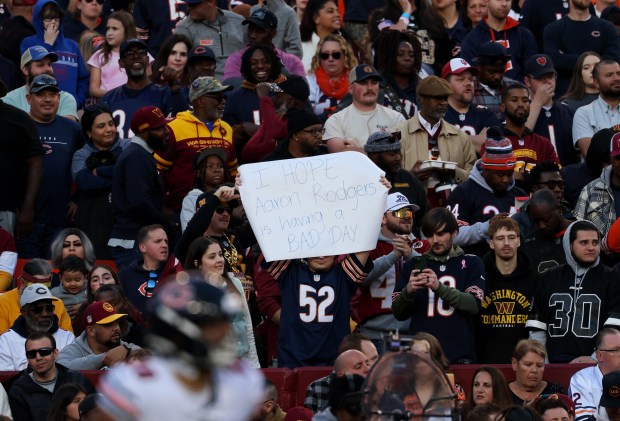 A Bears fan holds a sign mocking Jets quarterback Aaron Rodgers in the first quarter of a game between the Commanders and Bears at Northwest Stadium on Oct. 27, 2024, in Landover, Maryland. (John J. Kim/Chicago Tribune)