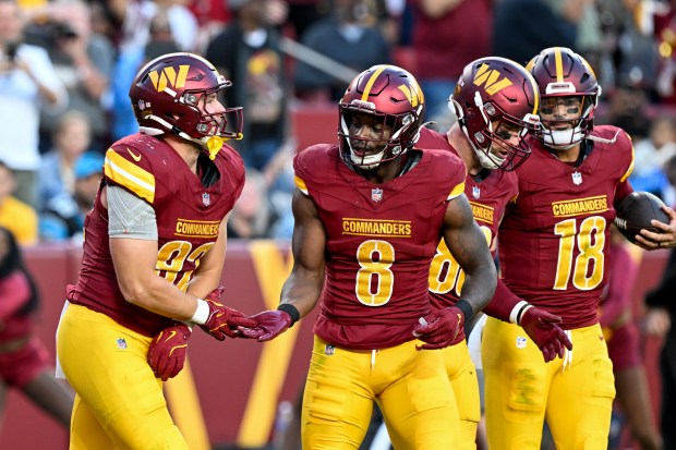 Ben Sinnott (82) of the Commanders celebrates with teammates after scoring a touchdown against the Panthers on Oct. 20, 2024, in Landover, Md. (Greg Fiume/Getty Images)