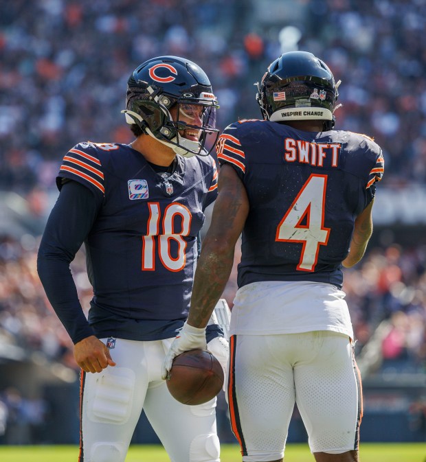 Bears running back D'Andre Swift celebrates with quarterback Caleb Williams after scoring a touchdown against the Panthers on Oct. 6, 2024, at Soldier Field. (Armando L. Sanchez/Chicago Tribune)