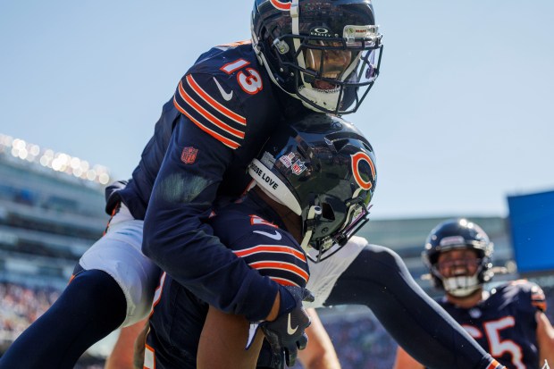 Chicago Bears wide receiver Keenan Allen (13) celebrates with Chicago Bears wide receiver DJ Moore (2) after Moore scored a touchdown during the second quarter against the Carolina Panthers at Soldier Field Sunday Oct. 6, 2024, in Chicago. (Armando L. Sanchez/Chicago Tribune)