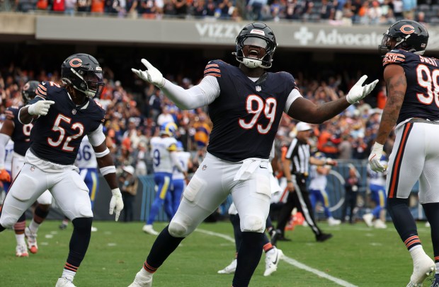 Bears defensive tackle Gervon Dexter and teammates celebrate a fourth-quarter interception by safety Jaquan Brisker to secure a win against the Rams on Sept. 29, 2024, at Soldier Field. (Brian Cassella/Chicago Tribune)