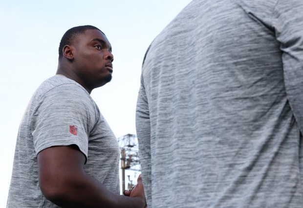 Bears lineman Kiran Amegadjie watches warmups before the Hall of Fame Game against the Texans at Tom Benson Hall of Fame Stadium on Aug. 1, 2024, in Canton. (John J. Kim/Chicago Tribune)