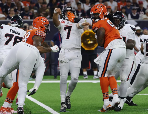 Texans quarterback C.J. Stroud takes a hand to the face from Bears defensive tackle Zacch Pickens on Sept. 15, 2024, at NRG Stadium in Houston. (John J. Kim/Chicago Tribune)