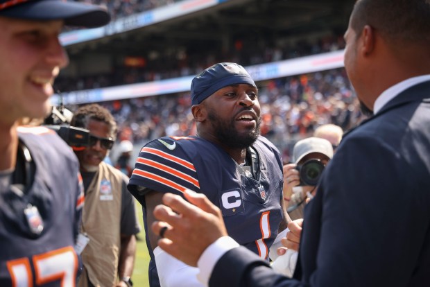 Chicago Bears cornerback Jaylon Johnson (1) celebrates the win with general manager Ryan Poles on Sept. 8, 2024, at Soldier Field. The Bears defeated the Titans 24-17. (Brian Cassella/Chicago Tribune)