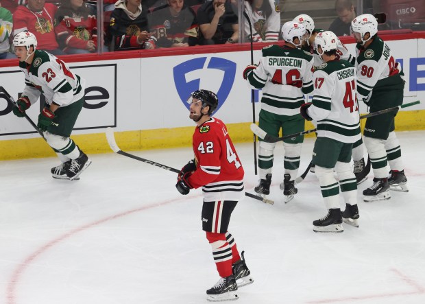 Blackhawks defenseman Nolan Allan (42) looks at the video replay as Wild center Marco Rossi (23) skates off after scoring in the first period of a preseason game at the United Center on Oct. 4, 2024, in Chicago. (John J. Kim/Chicago Tribune)