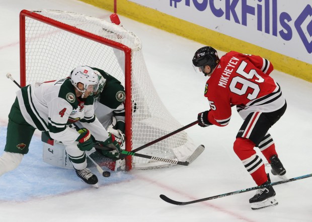 Blackhawks right wing Ilya Mikheyev (95) attempts to get the puck into the Wild goal in the second period of a preseason game at the United Center on Oct. 4, 2024, in Chicago. (John J. Kim/Chicago Tribune)