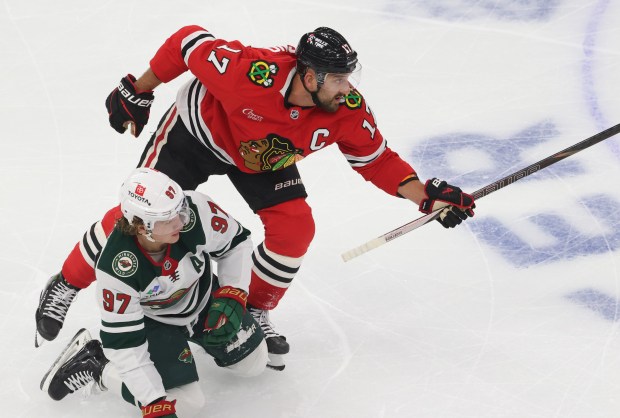 Blackhawks left wing Nick Foligno (17) skates past Wild left wing Kirill Kaprizov (97) in the first period of a preseason game at the United Center on Oct. 4, 2024, in Chicago. (John J. Kim/Chicago Tribune)