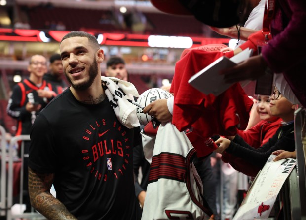 Bulls guards Lonzo Ball signs autographs before a preseason game against the Cavaliers at the United Center on Oct. 18, 2024, in Chicago. (John J. Kim/Chicago Tribune)