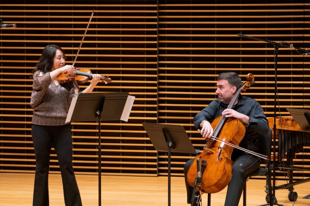 Violinist Yuan-Qing Yu and cellist Ken Olsen perform in DePaul University's Allen Recital Hall in Chicago on April 7, 2024. (MJ Mui)