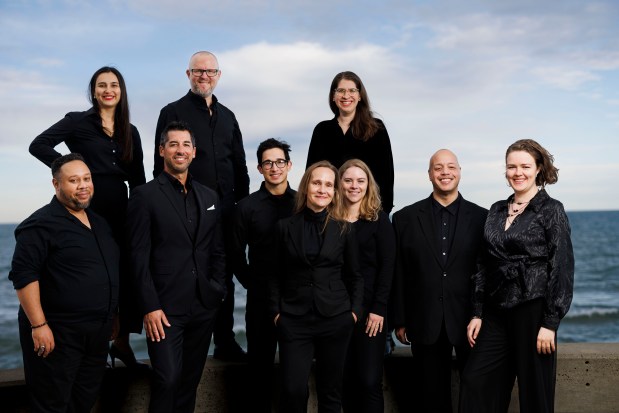 From top to bottom left to right, new earth ensemble members Gabrielle Timofeeva López, Steven Wilson, Hannah Dixon McConnell, John E. Orduña, Joe Labozetta, Nikhil Harle, choral director Kirsten Hedegaard, Katherine Buzard, Trevor L. Mitchell, and Allison Selby Cook pose for a portrait at Loyola University, Oct. 7, 2024, in Chicago. (Armando L. Sanchez/Chicago Tribune)