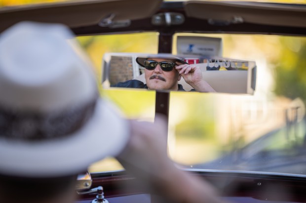 Art Martin, vice president of the Pura Familia Car Club, poses for a portrait inside his 1947 Chevrolet Fleetmaster convertible, which he will ride in the upcoming Chicago Lowrider Festival at Navy Pier, at his home in Shorewood on Oct. 8, 2024. (Tess Crowley/Chicago Tribune)