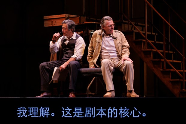 Adrian Pang and Tom McCamus, along with surtitles, in "Salesman in China" in the Avon Theatre at the Stratford Festival in Canada. (David Hou)