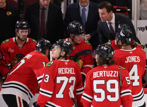 Blackhawks head coach Luke Richardson, top right, talks to players during a timeout in the third period against the Predators at the United Center on Oct. 25, 2024, in Chicago. (John J. Kim/Chicago Tribune)