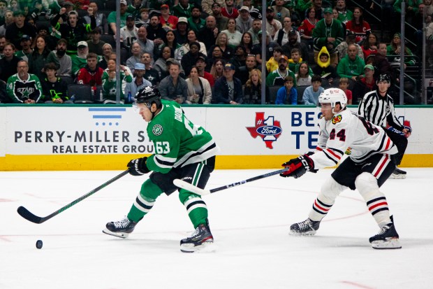 Stars right wing Evgenii Dadonov skates past Blackhawks defenseman Wyatt Kaiser during the first period Saturday, Oct. 26, 2024, in Dallas. (AP Photo/Emil T. Lippe)