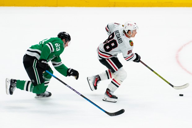 Blackhawks center Connor Bedard skates past Stars defenseman Esa Lindell during the first period Saturday, Oct. 26, 2024, in Dallas. (AP Photo/Emil T. Lippe)