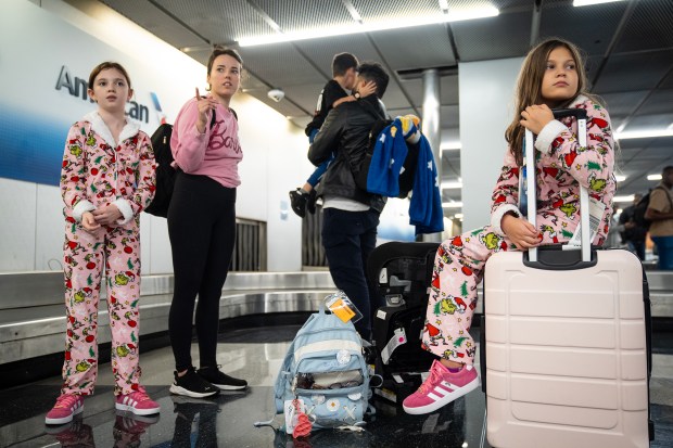 The Cantrell family arrives at O'Hare International Airport after evacuating their home near Miami ahead of Hurricane Milton on Oct. 9, 2024. They are headed to stay with family in Washington, Illinois. (E. Jason Wambsgans/Chicago Tribune)