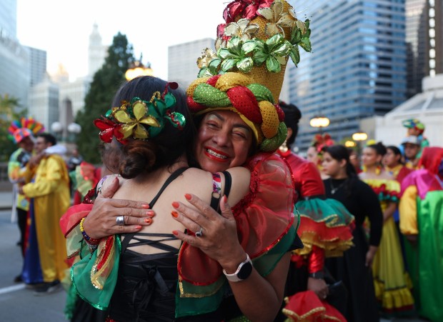 Carmen Barrio, right, hugs Maria Hernandez before marching in the Arts in the Dark Halloween Parade. (John J. Kim/Chicago Tribune)