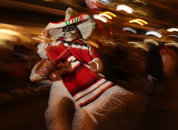 A parade participant dances during the Arts in the Dark Halloween Parade on State Street Saturday, Oct. 19, 2024, in Chicago. (John J. Kim/Chicago Tribune)