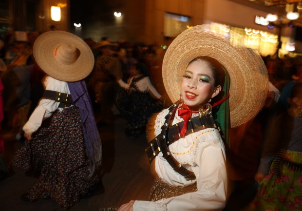 A parade participant with the Chicago Día de Los Niños dances during the Arts in the Dark Halloween Parade on Oct. 19, 2024. (John J. Kim/Chicago Tribune)