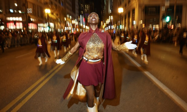 Deborah Kpogo performs with the Southland College Prep Charter High School Lady Eagles during the Arts in the Dark Halloween Parade on State Street on Oct. 19, 2024. (John J. Kim/Chicago Tribune)