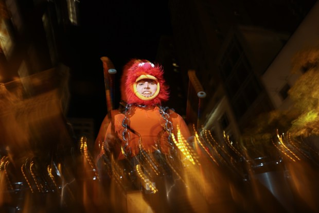 A drummer dressed as The Muppets Show character Animal, who also plays drums, performs during the Arts in the Dark Halloween Parade. (John J. Kim/Chicago Tribune)