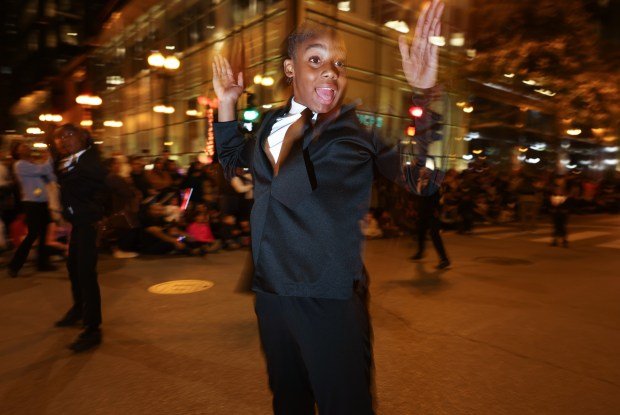 A parade participant dances with others during the Arts in the Dark Halloween Parade. (John J. Kim/Chicago Tribune)