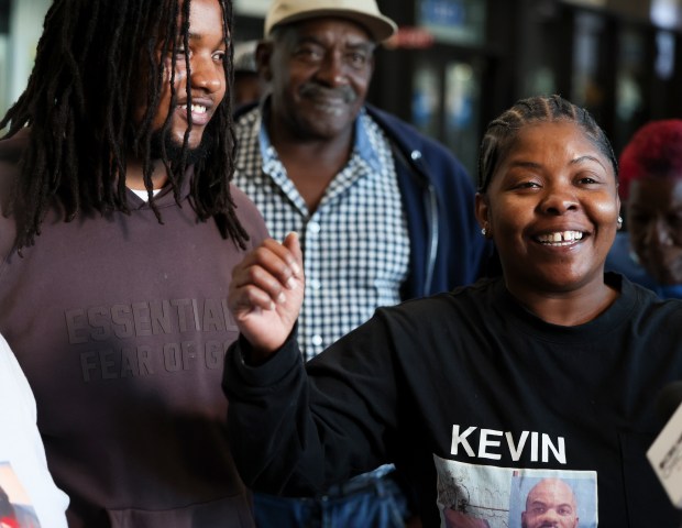 Lakisha Jackson stands with her son, Shawn Palmer, and father, James Perkins, and answers questions at the Leighton Criminal Court Building on Oct. 7, 2024, after an appellate court ordered her brother, Kevin Jackson, be released while an appeal is pending. (Eileen T. Meslar/Chicago Tribune)